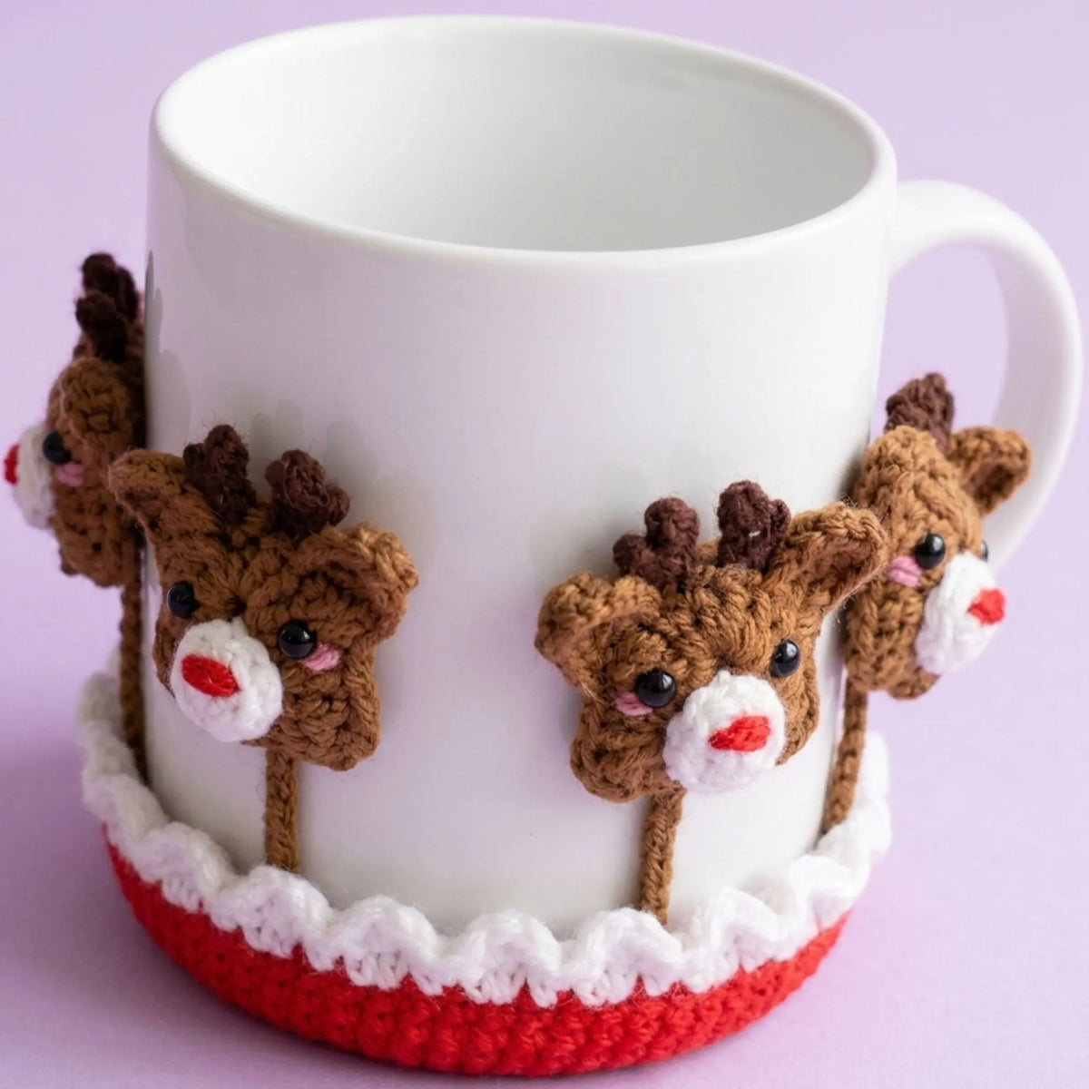 Reindeer crochet coaster figures around a white holiday mug