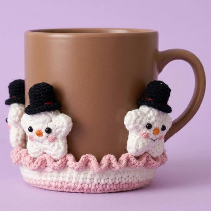 Snowman crochet coaster figures with top hats around a brown mug