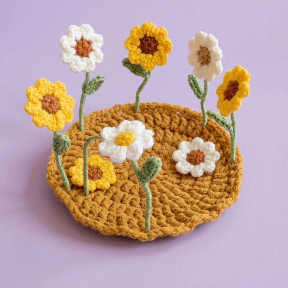 Sunflower and daisy pop-up crochet coaster on a golden base