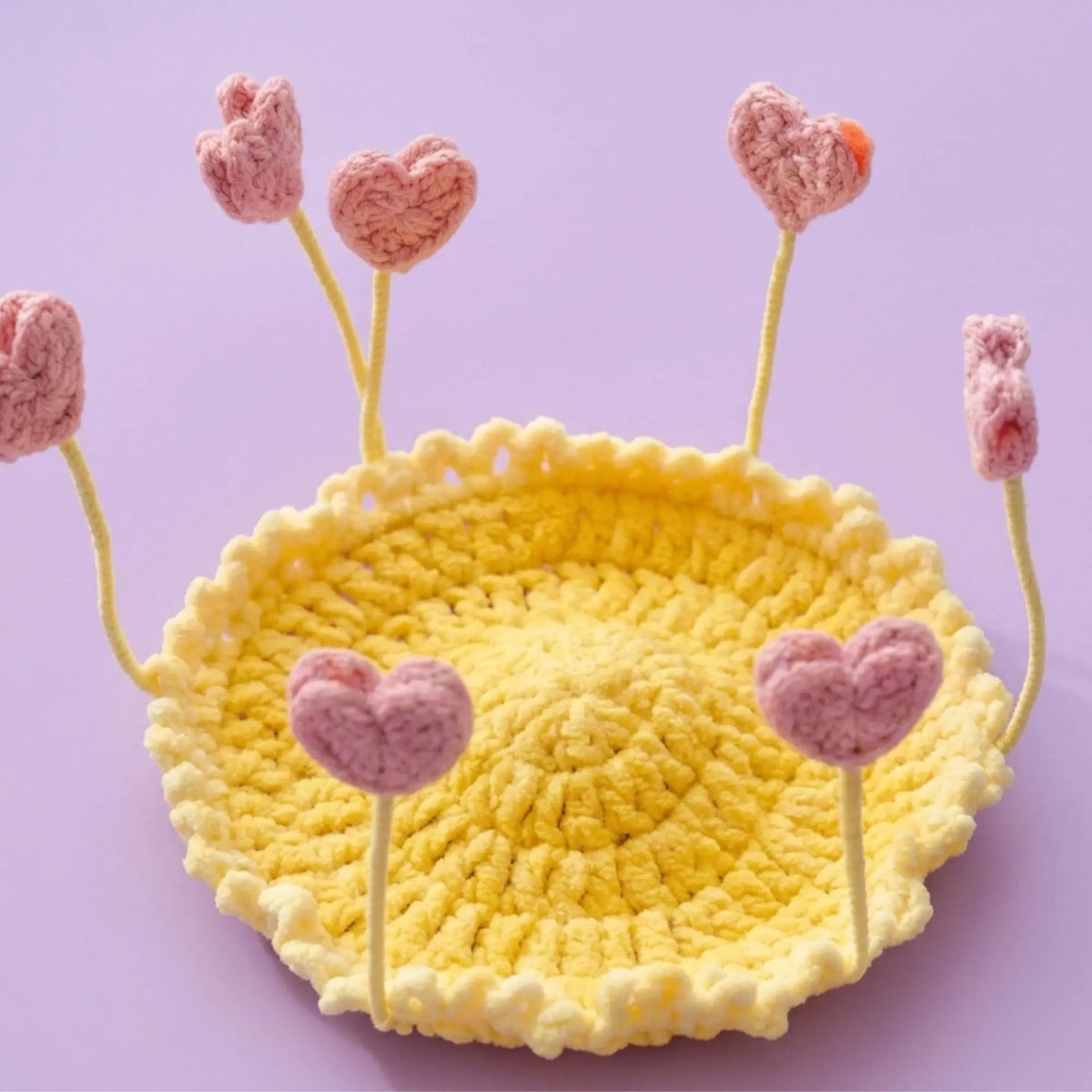 Pink heart pop-up crochet coaster on a yellow base, Valentine idea