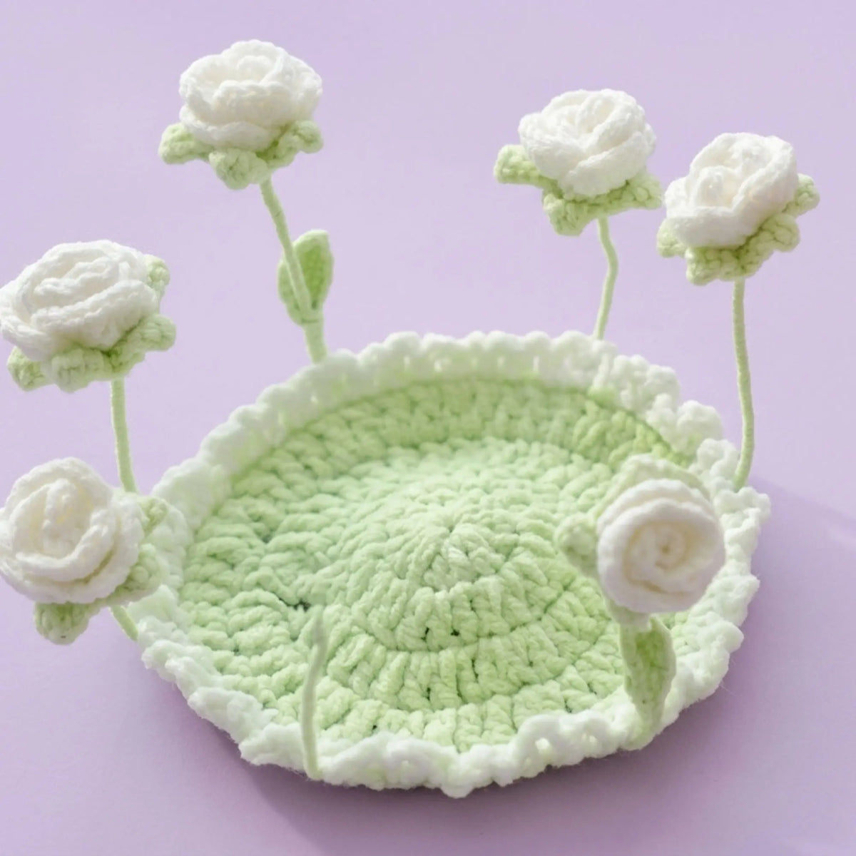 White rose pop-up crochet coaster on a mint green base
