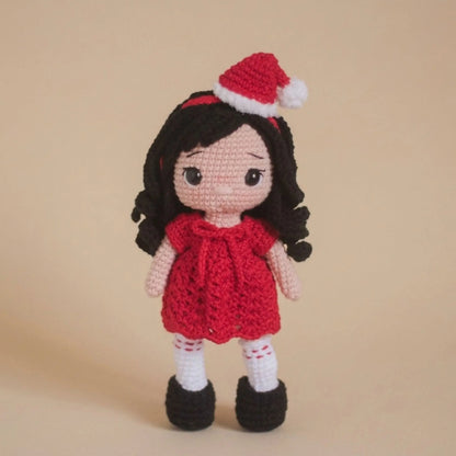 Christmas doll crochet pattern: amigurumi girl with black hair, red dress, Santa hat and boots
