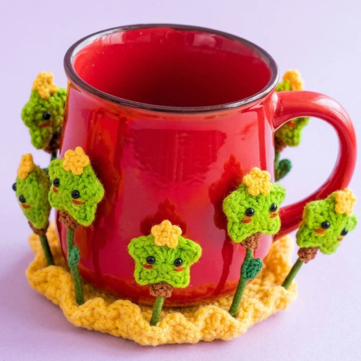 Red mug on a crochet coaster with green and yellow star flowers