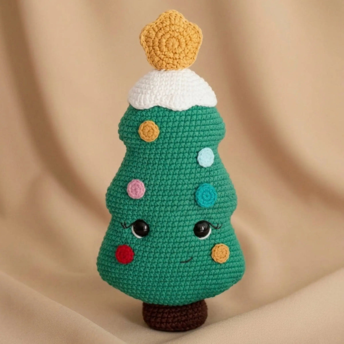 Crochet Christmas tree amigurumi with colorful ornaments, snowy top and gold star