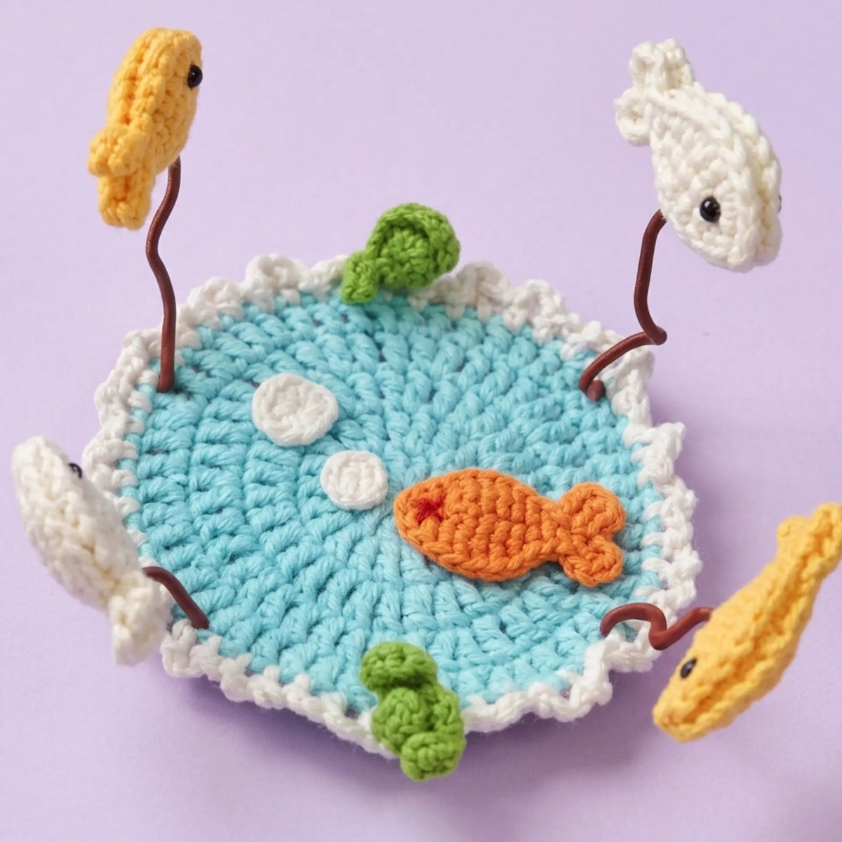 Goldfish pond crochet coaster with fish and lily pads on wire stems