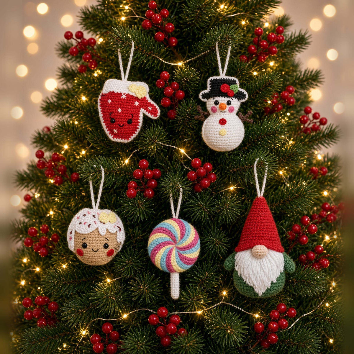 5 cozy crochet Christmas ornaments hanging on a Christmas tree: gingerbread, mitten, gnome, snowman and lollipop