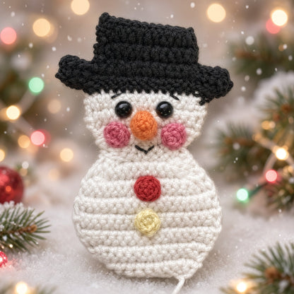 Crochet snowman Christmas ornament with a black top hat and orange carrot nose
