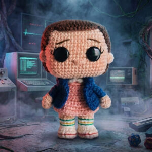Crocheted Eleven character inspired by Stranger Things, handmade amigurumi doll with short hair and iconic outfit, digital crochet pattern.